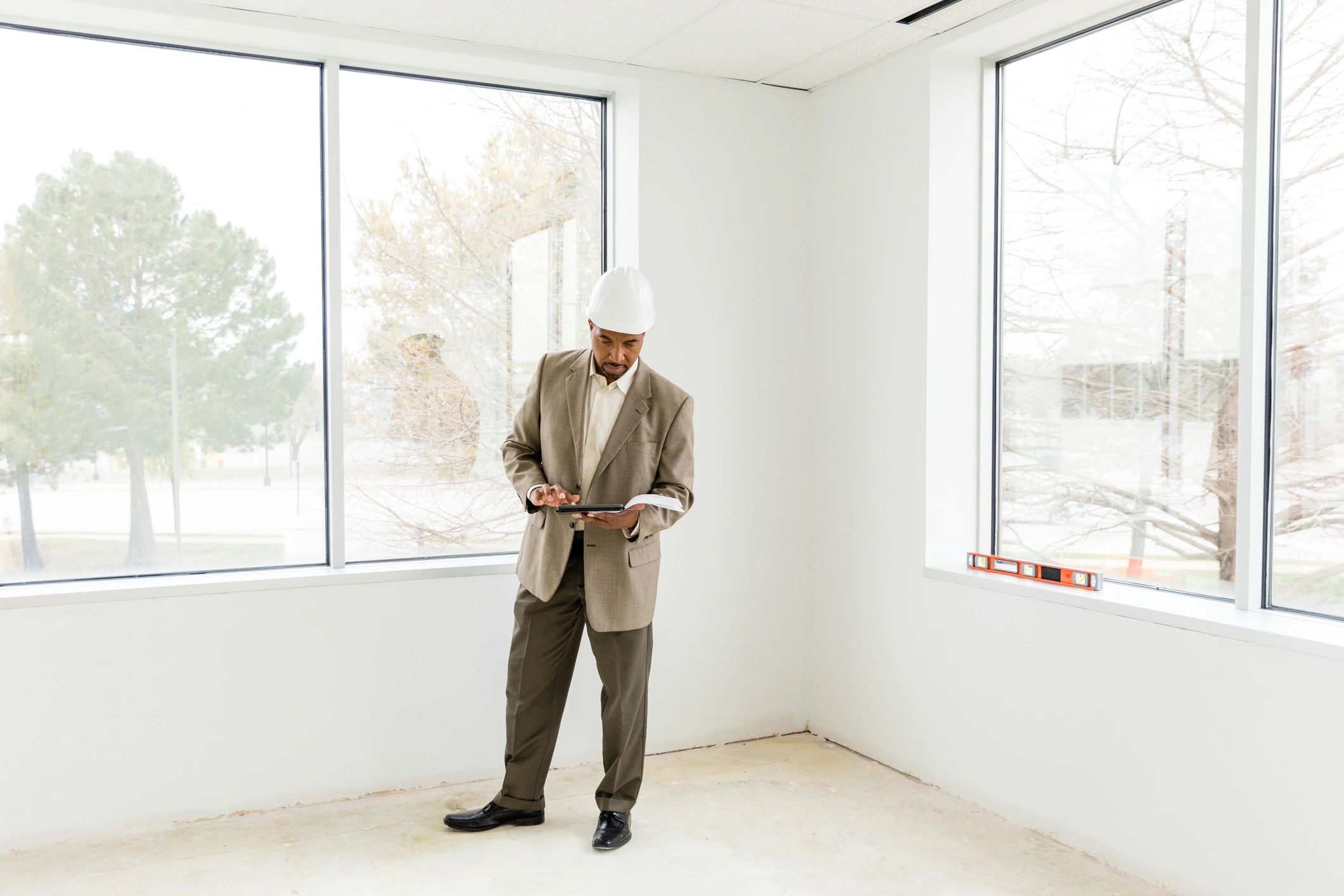Project manager reviewing plans on a tablet at a jobsite