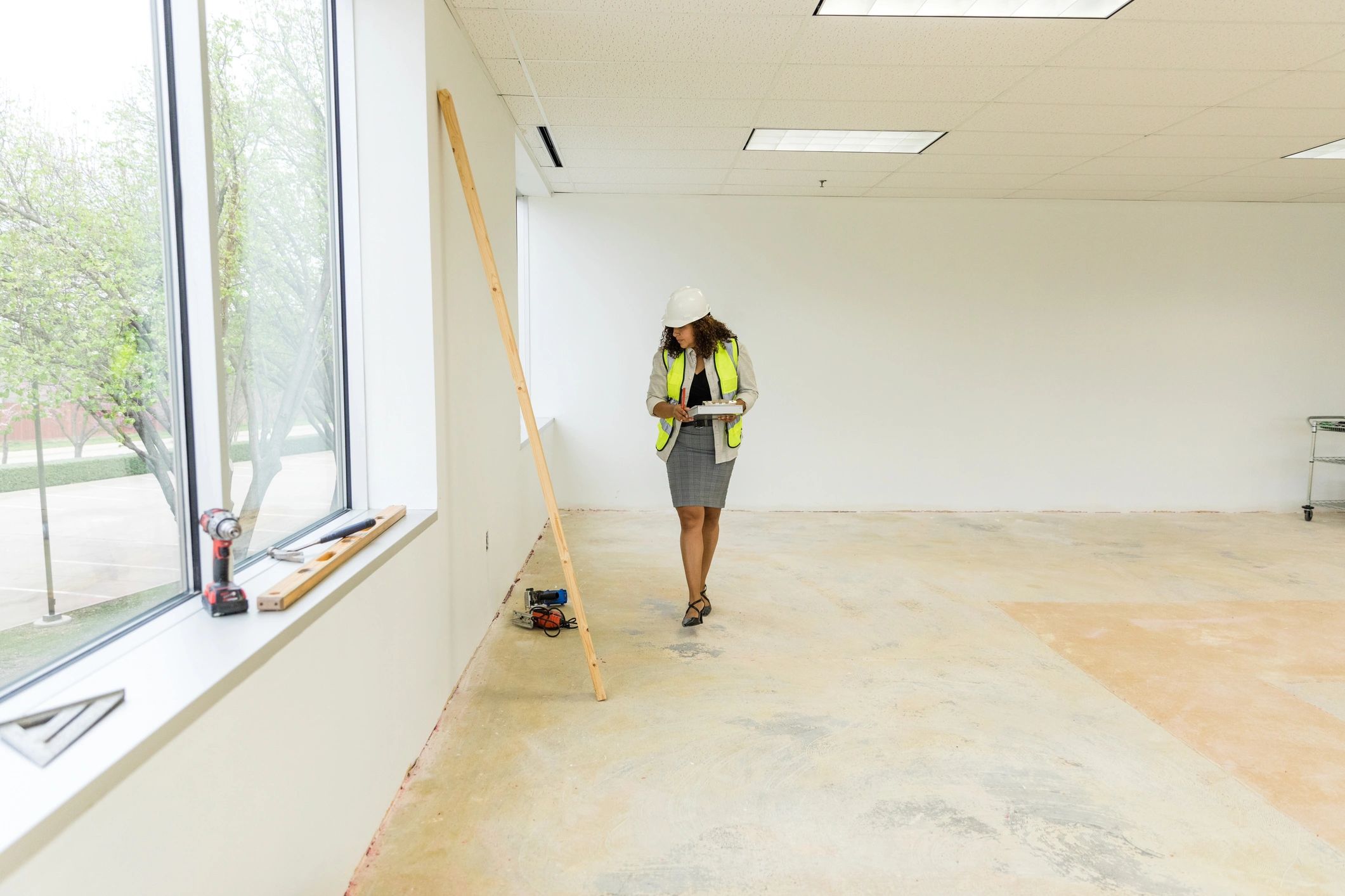 Inspector walking through a renovation space with a checklist