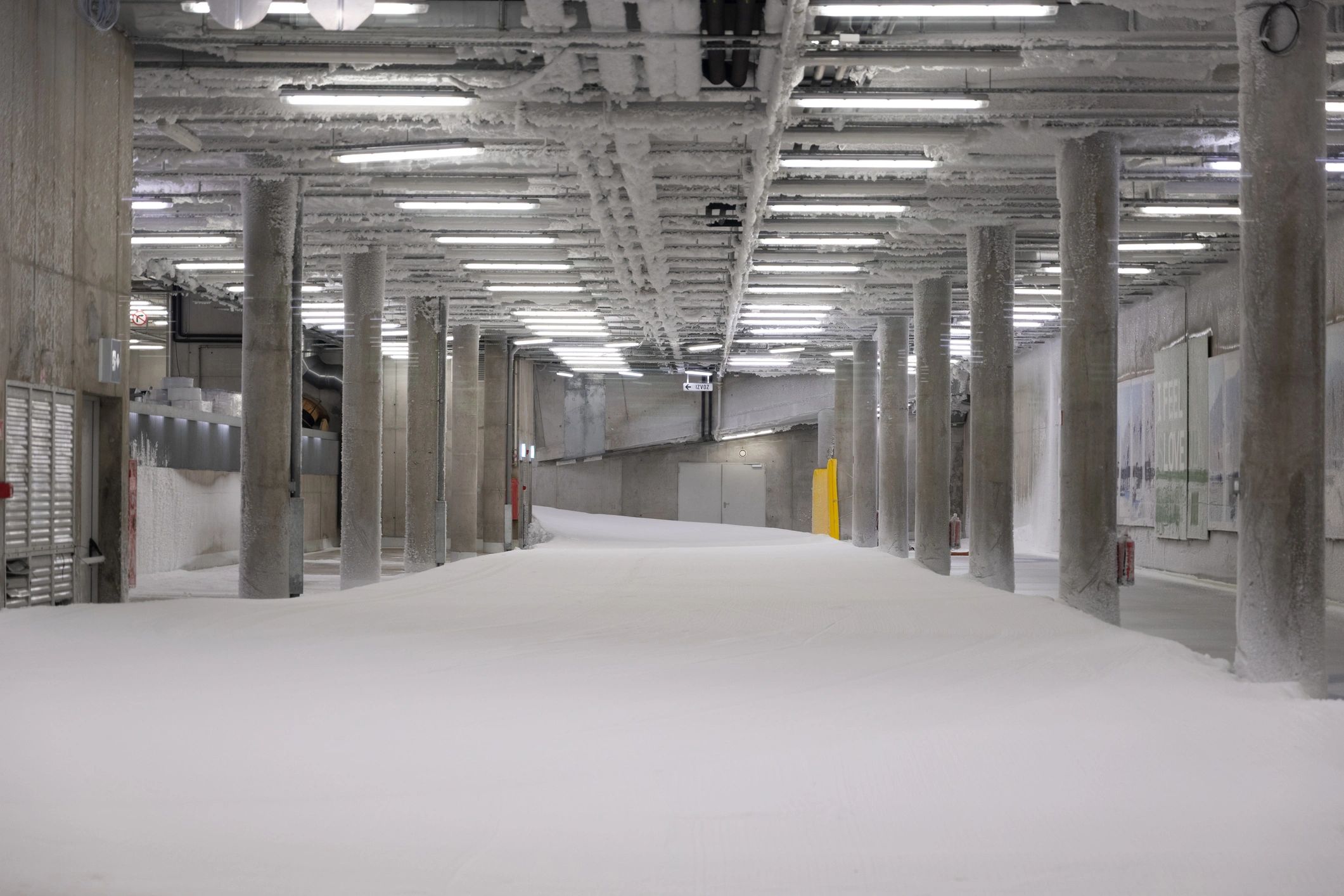 Concrete parking structure interior with pillars and lighting